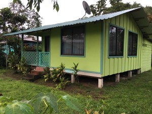 small green Caribbean house on stilts